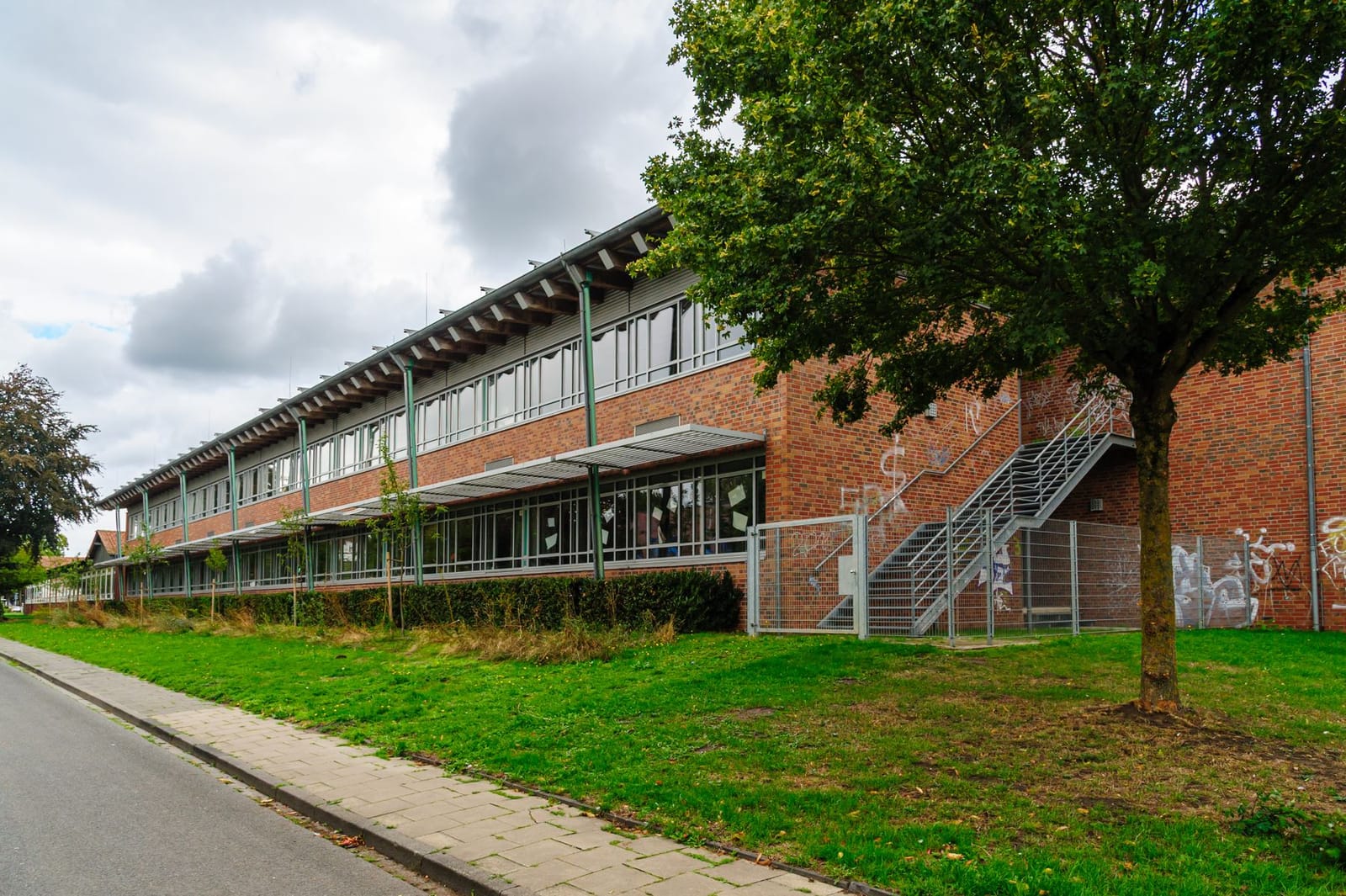 Brick school building with a green lawn